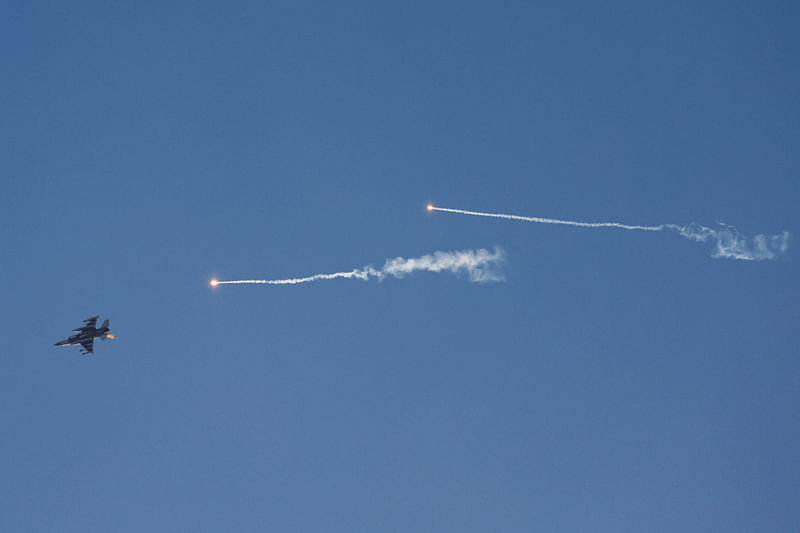 This picture taken from a position in northern Israel shows an Israeli Air Force fighter jet firing flares as it flies to intercept a hostile craft that launched from Lebanon over the border area with south Lebanon on July 7, 2024, amid ongoing cross-border clashes between Israeli troops and Hezbollah fighters